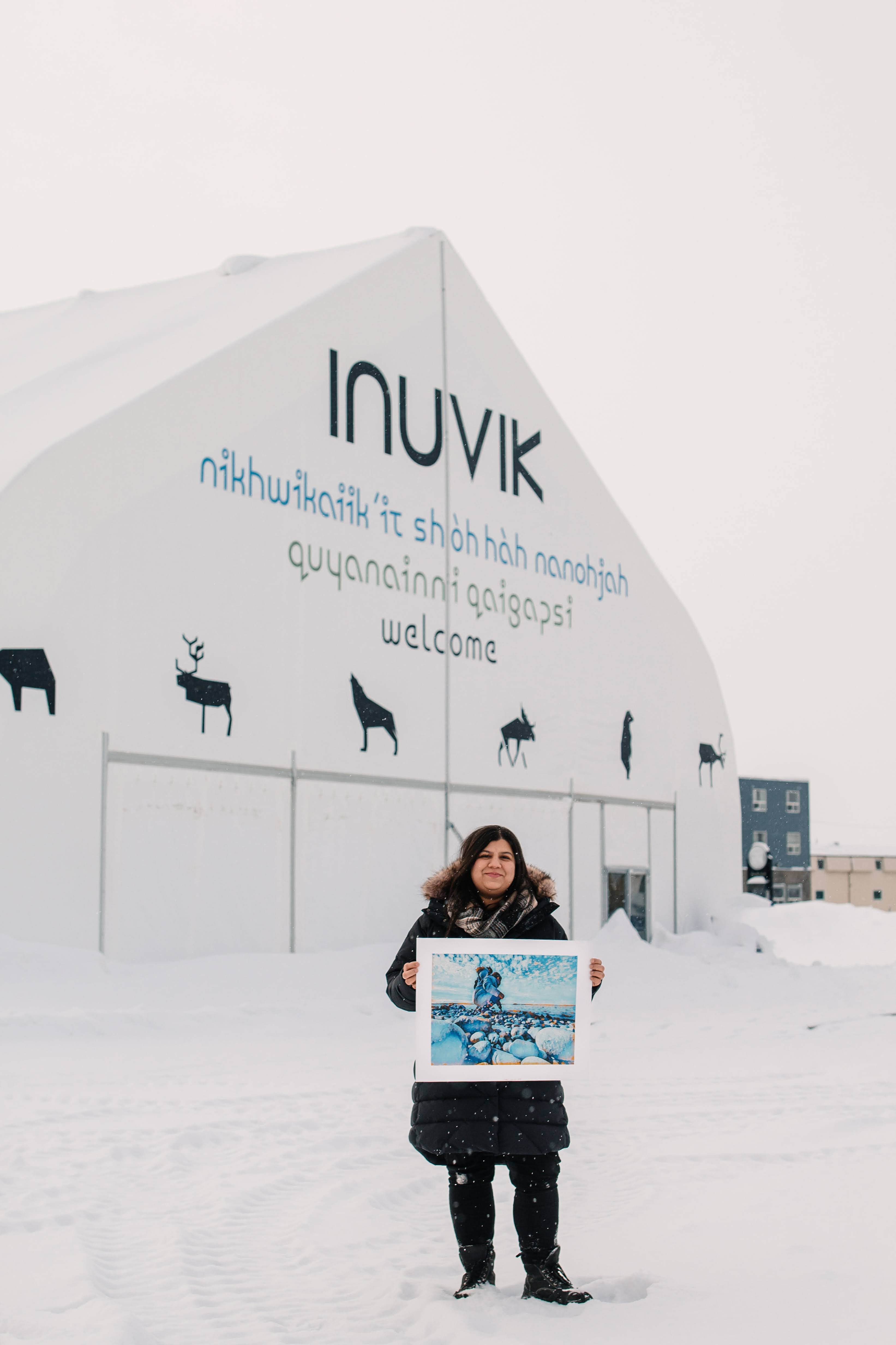 Sehrish standing in front of the Inuvik Welcome Centre
