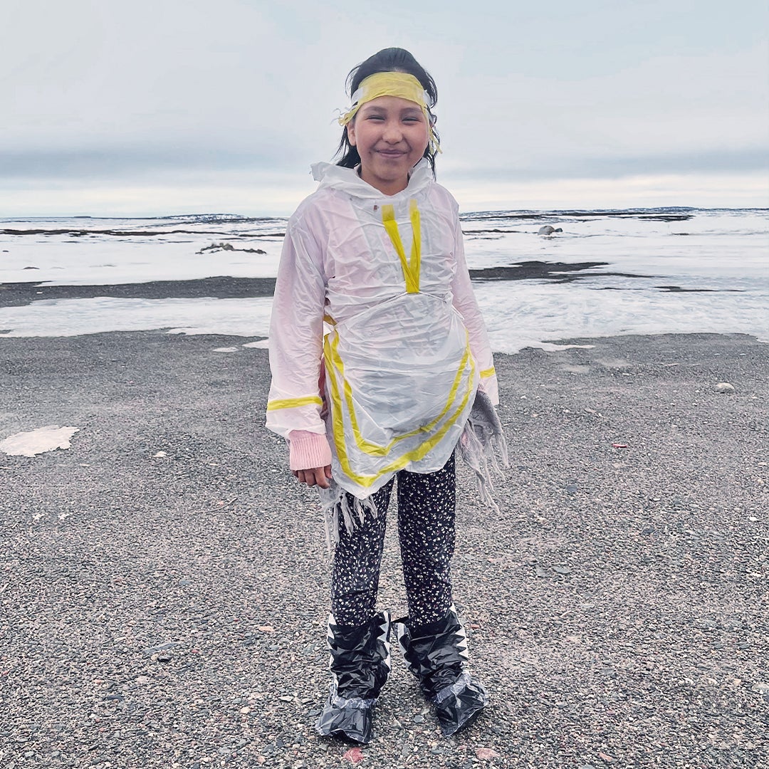 Young girl with an amauti made of plastic bags.