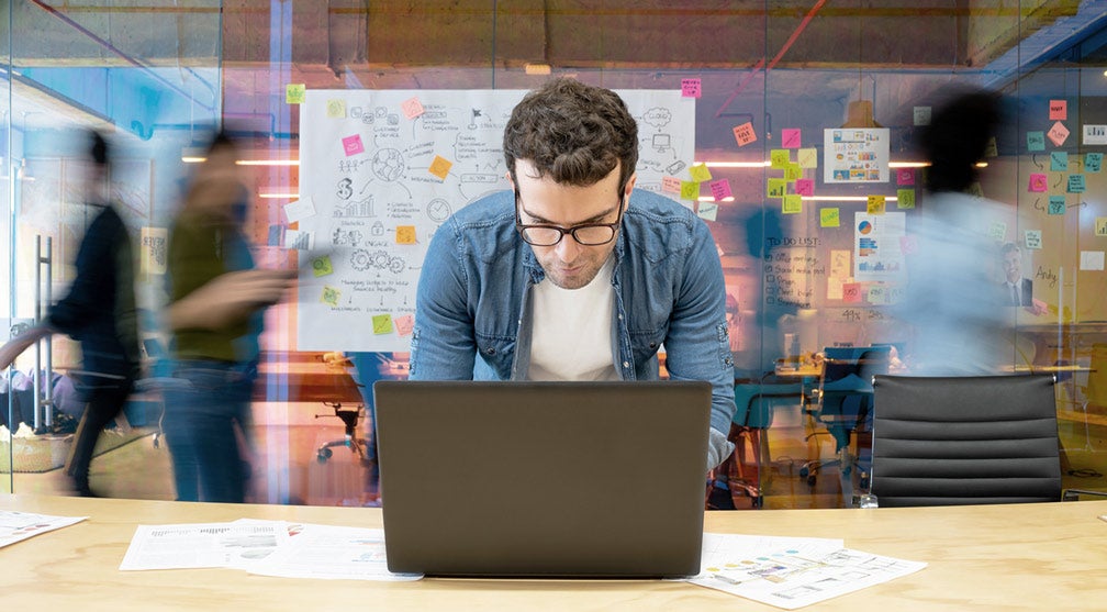 Man working on a computer portraying a creative working environment