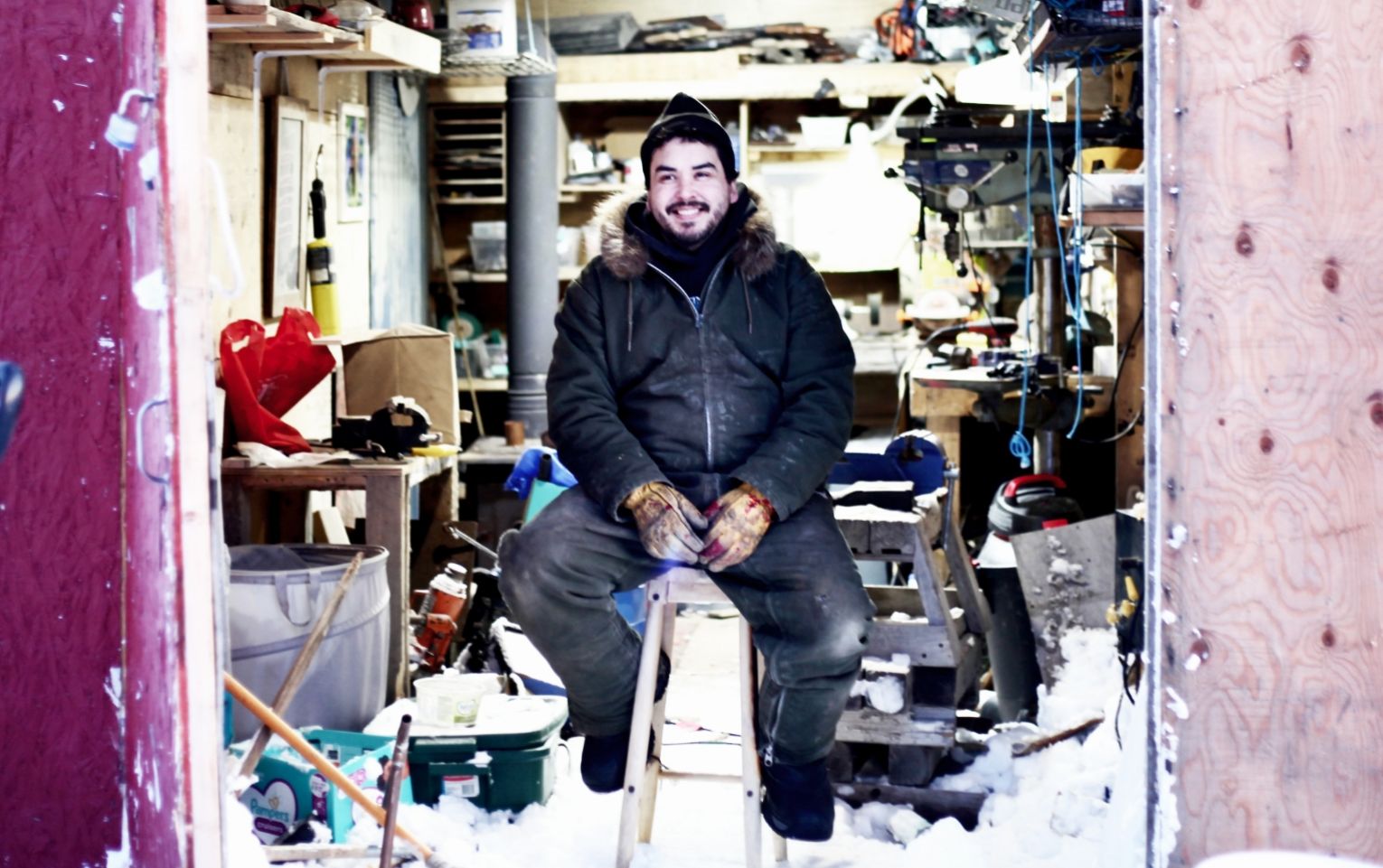 Nooks sitting in his workshop in Arviat, Nunavut