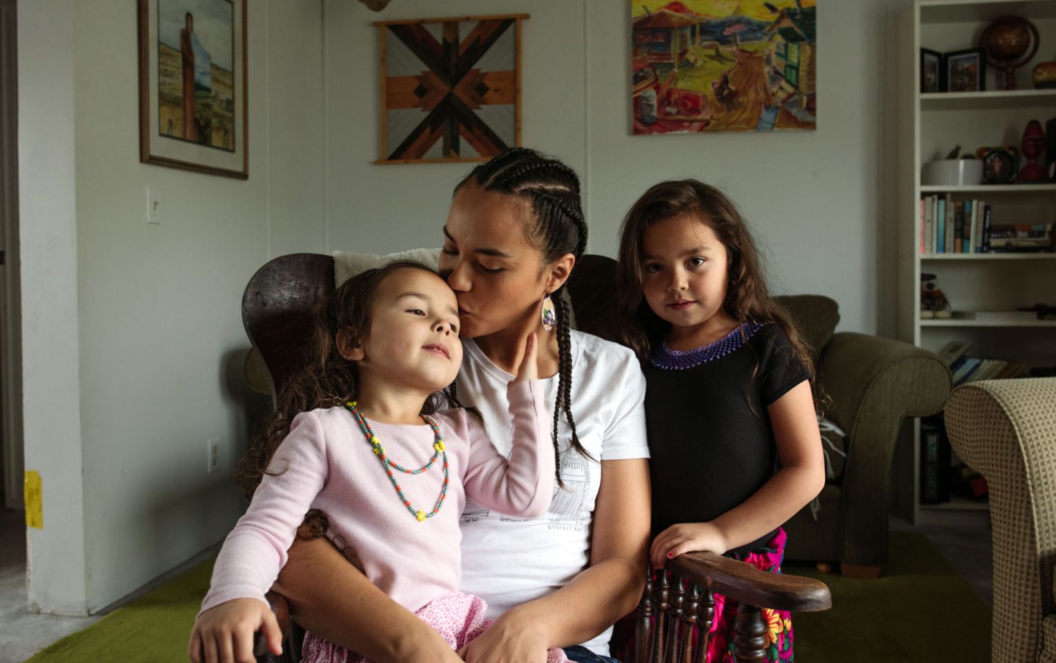 A photo of an Indigenous family from Northern Canada, sitting on a couch