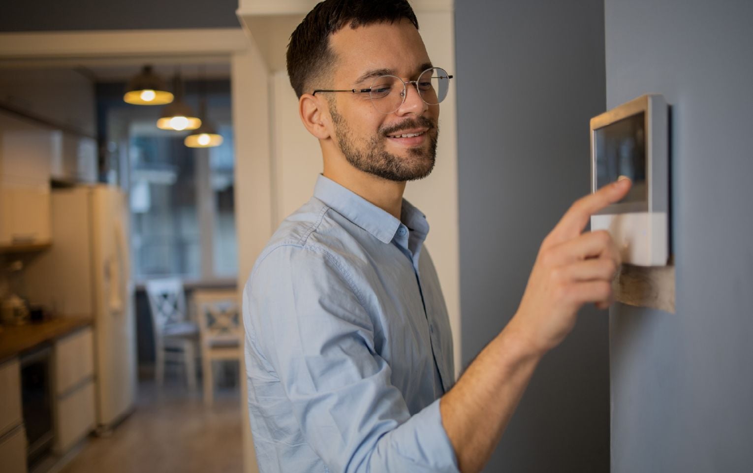 Person adjusting temperature using a smart thermostat