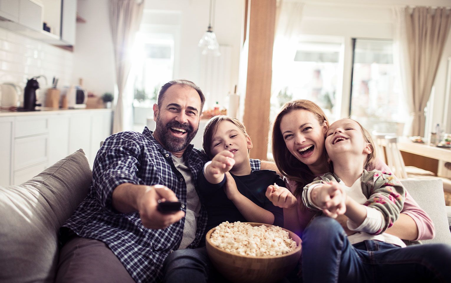 family watching TV and eating popcorn together