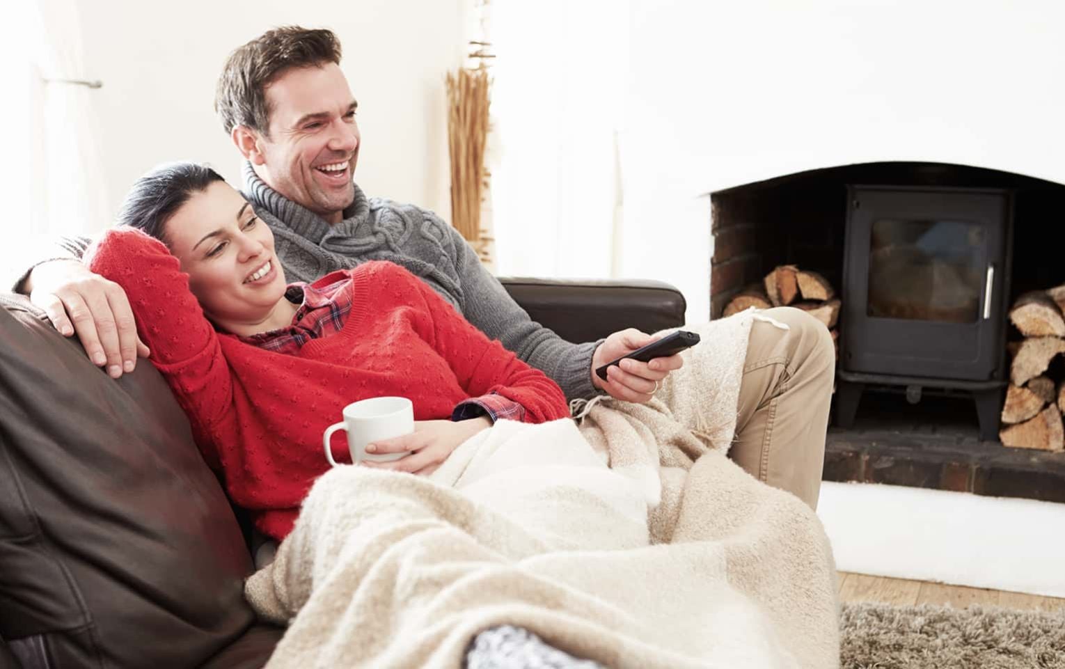 couple relaxing on couch watching tv