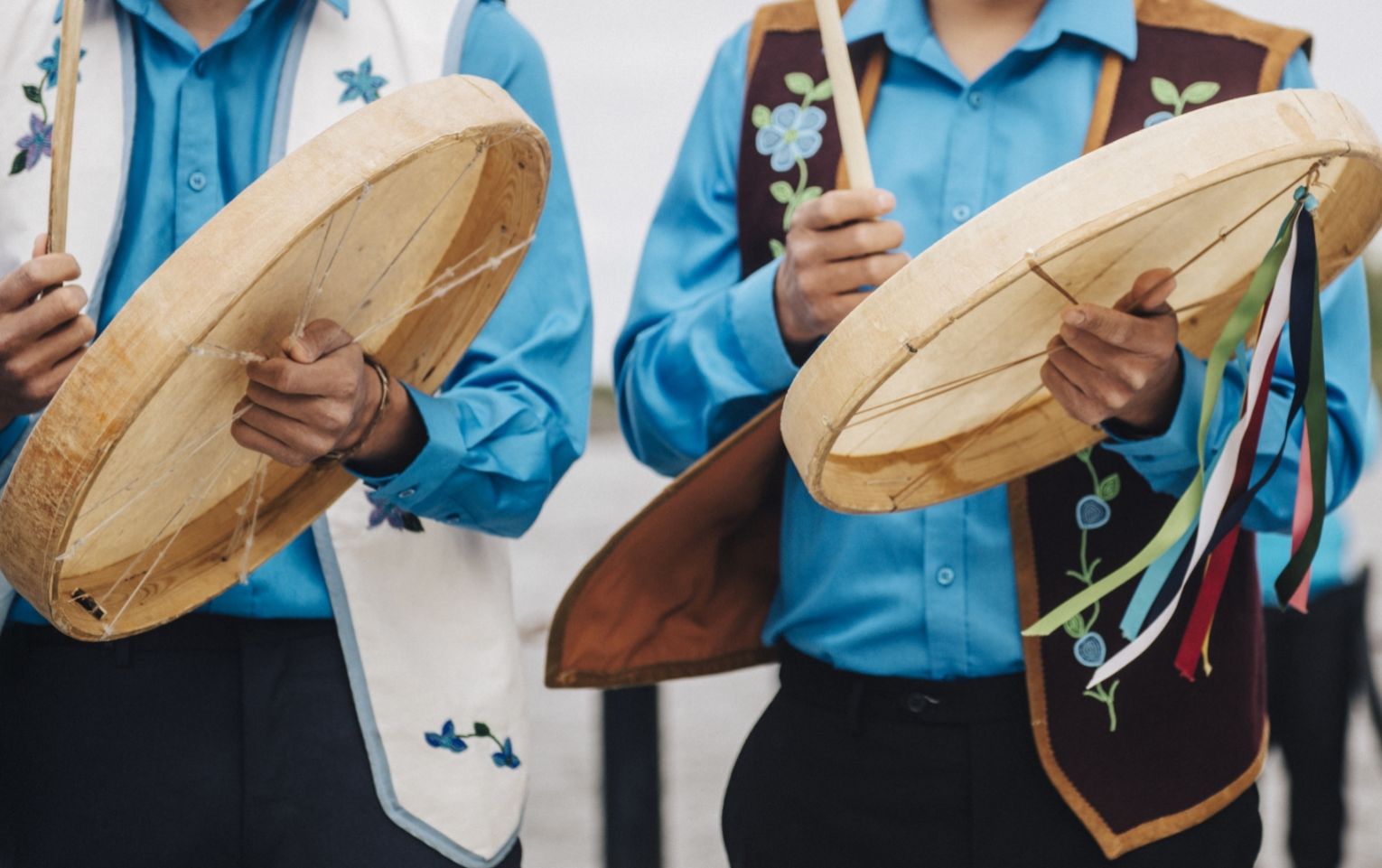 Indigenous drummers wearing traditional clothes playing for Indigenous day celebrations