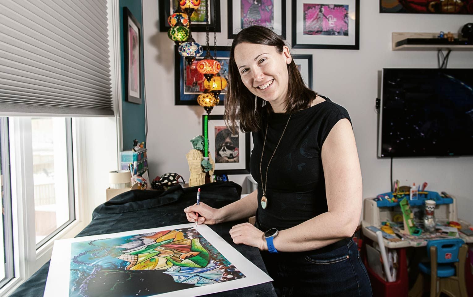 Woman at desk with art piece