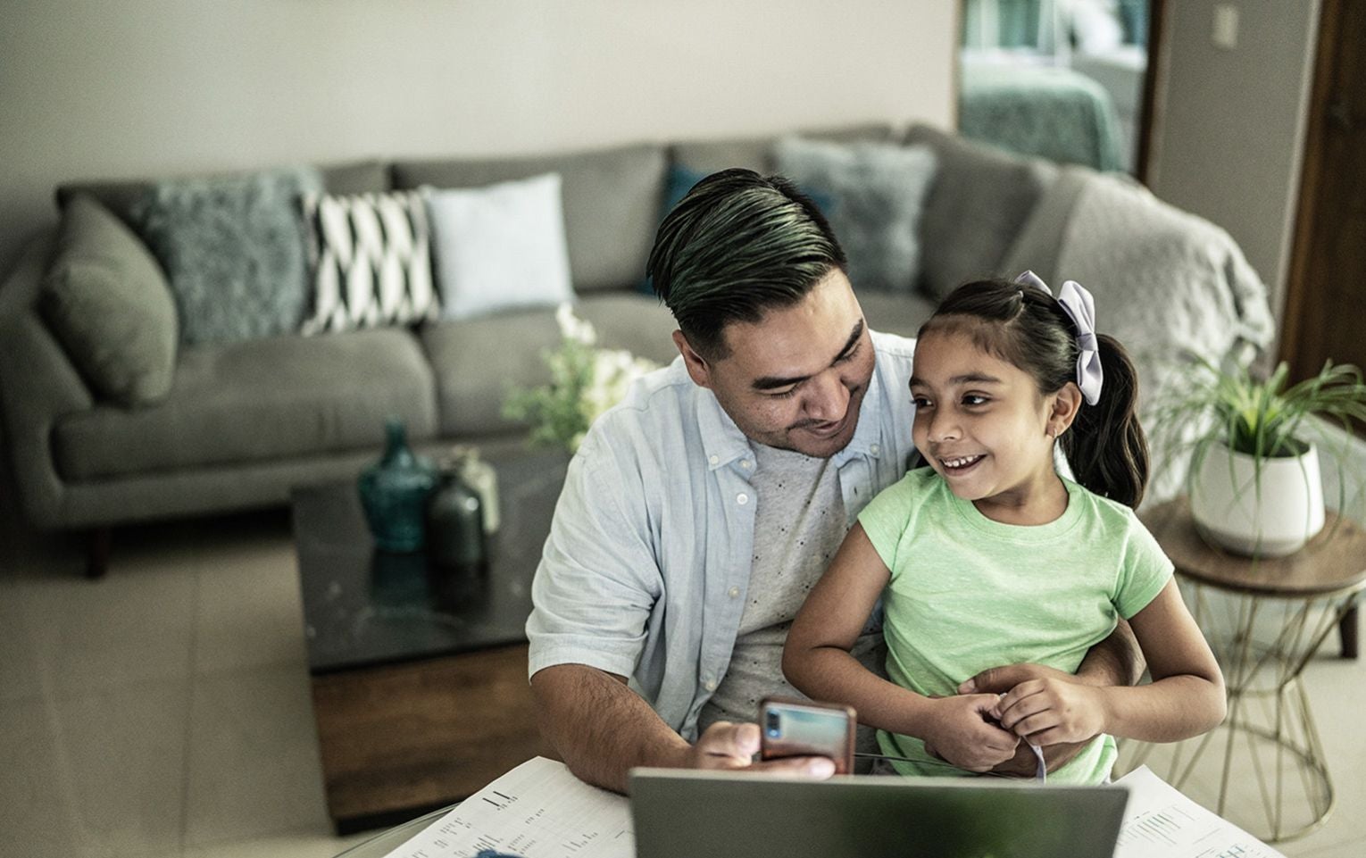 Dad on laptop with daughter