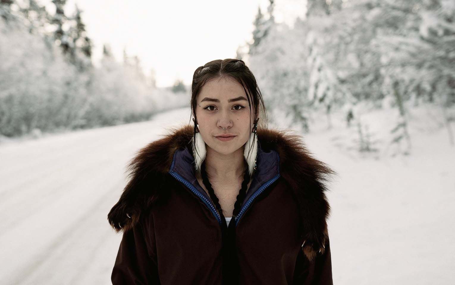 Woman standing on snowy road