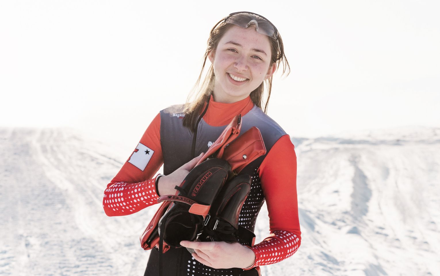 Nunavut speed skater Akutaq smiling with her skates