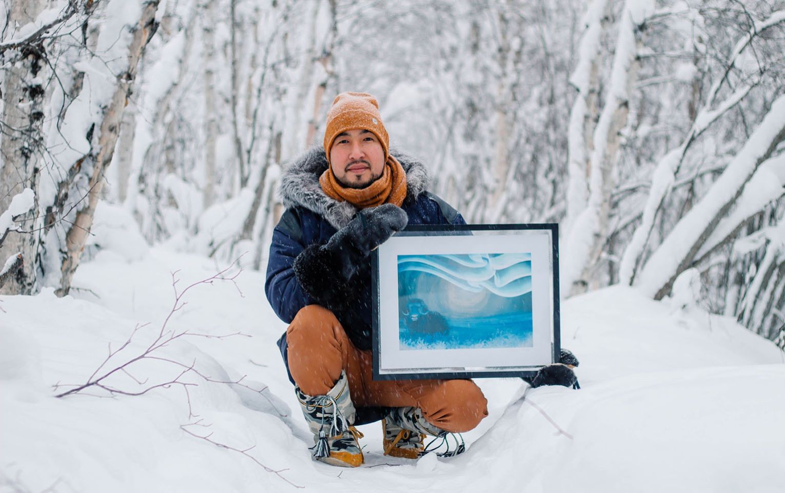 Brian Kowikchuk and a print of his digital artwork, Uumingmak (Muskox).