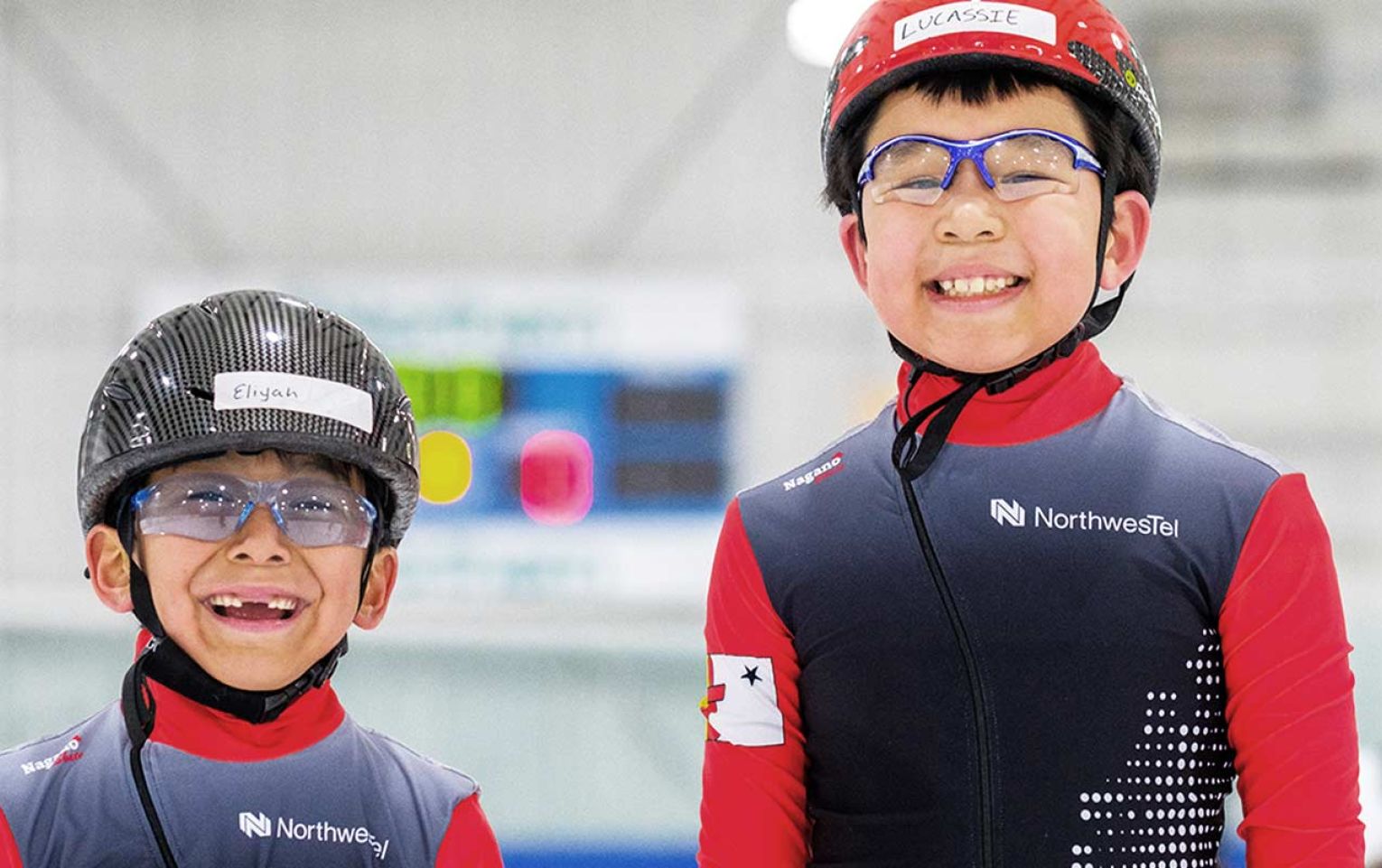 two smiling speed skaters