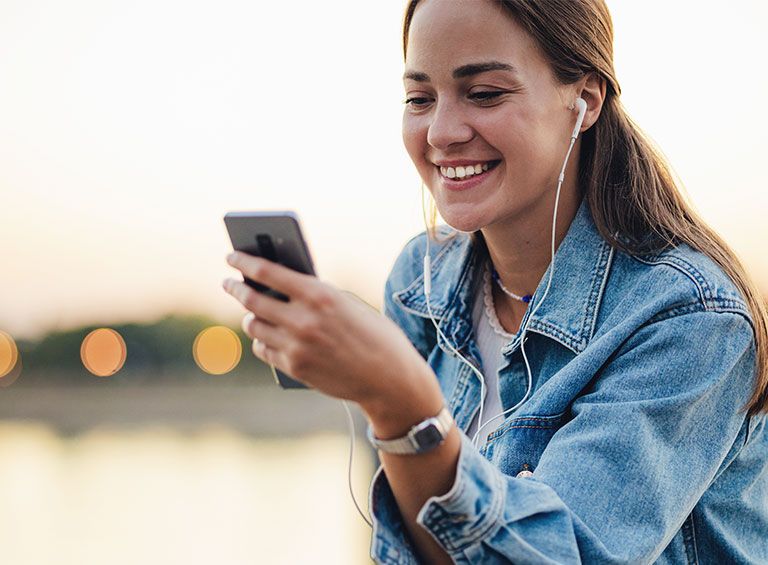 Woman smiling while holding phone