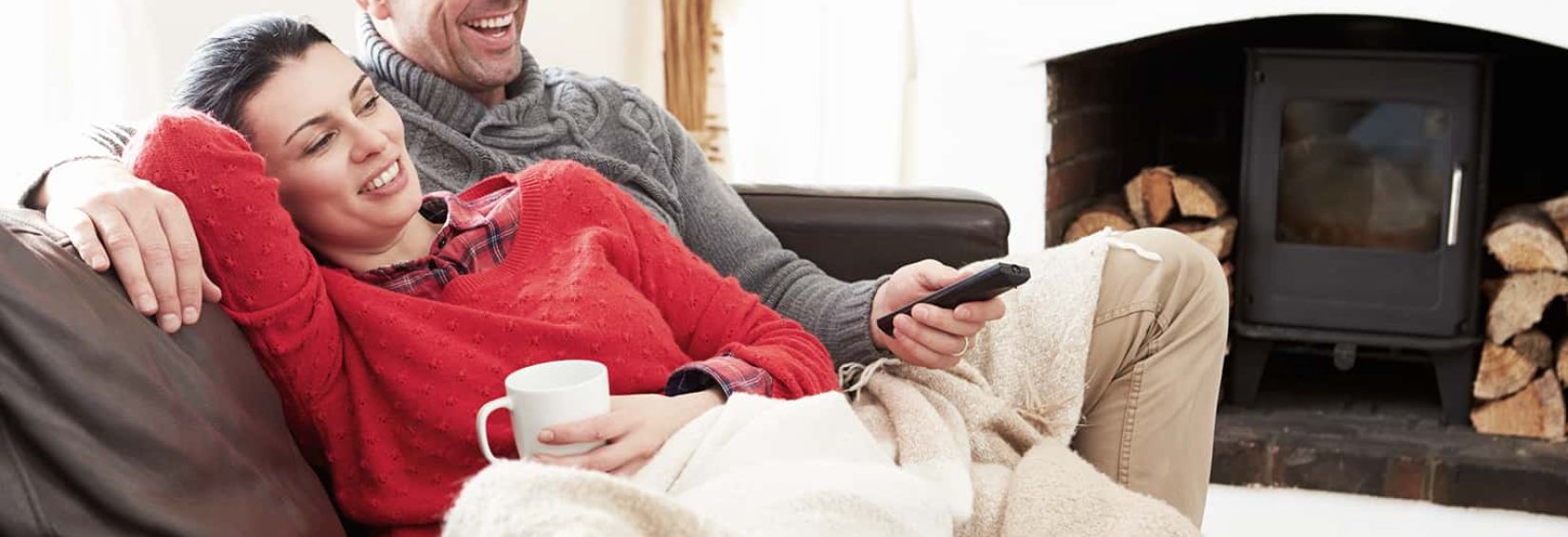 Top 5 VOD titles to watch! couple relaxing on couch watching tv