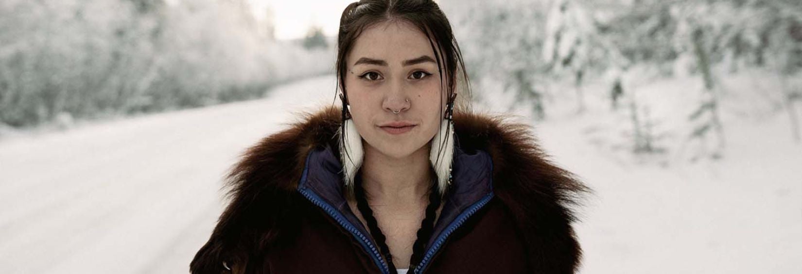 Woman standing on snowy road