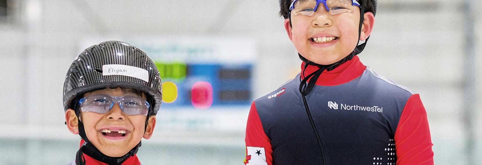 two smiling speed skaters