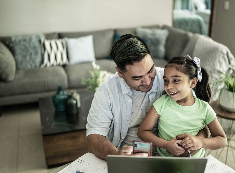 Dad on laptop with daughter